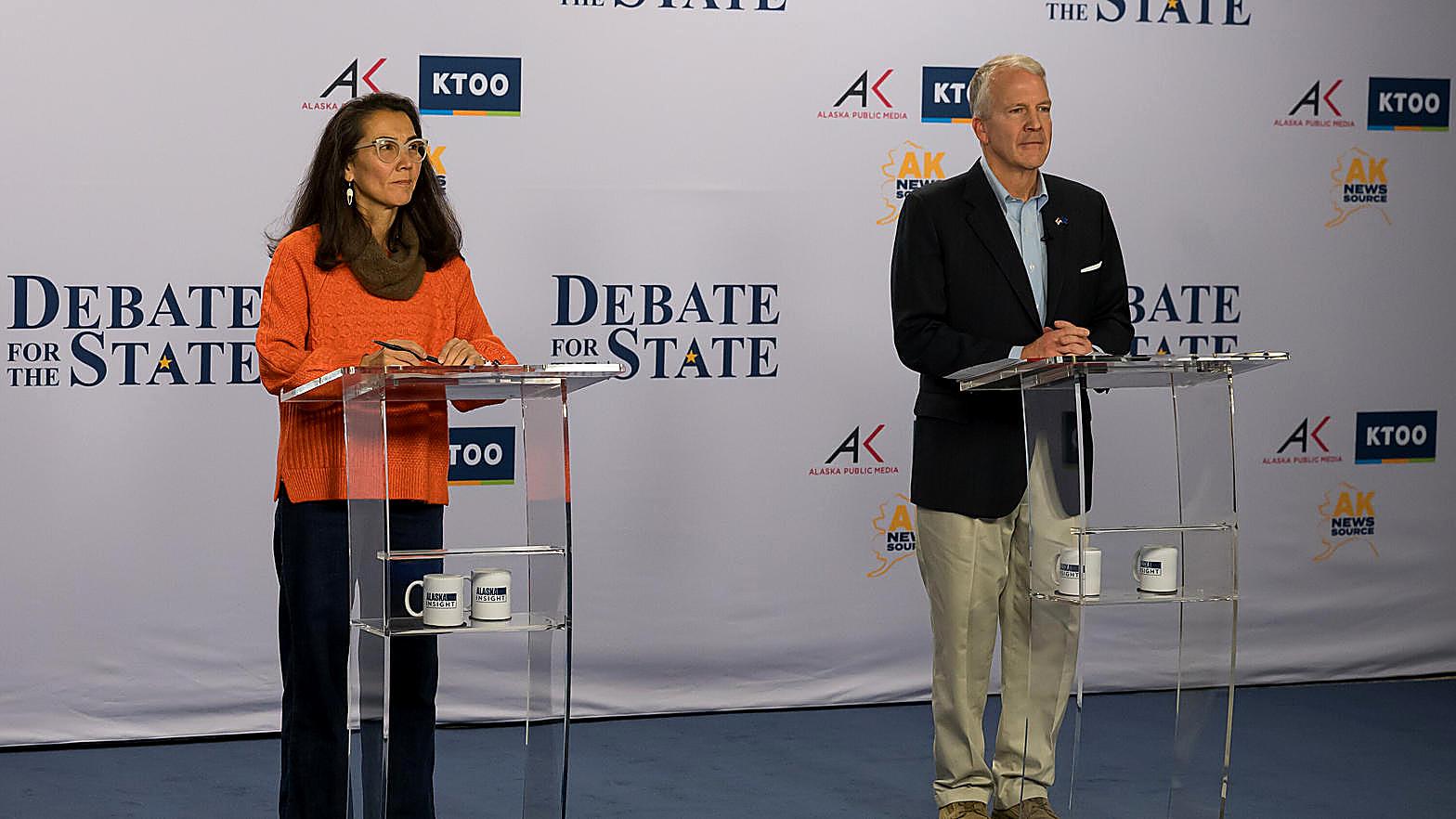 Mary Peltola and Sen. Dan Sullivan stand at their lecterns during the Alaska Senate debate.