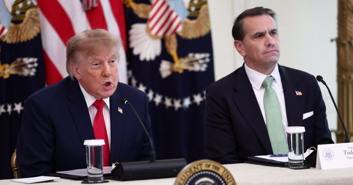 President Trump speaks at a White House table while Attorney General Todd Blanche sits beside him. Both faces are in the frame.