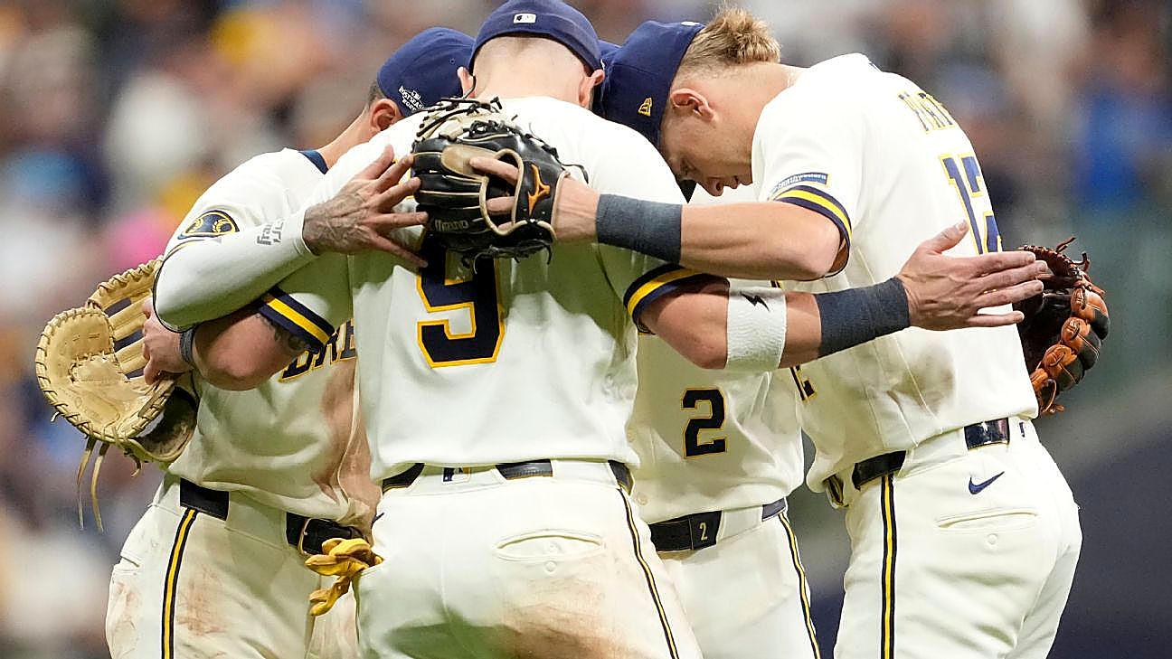 Milwaukee Brewers players meet on the field after beating the Dodgers in the NLCS opener.