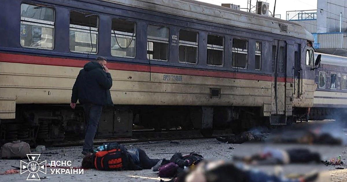 Ukraine's emergency service photograph of a damaged carriage at the Dnipro station. A man stands with a phone. It is Thursday's strike. It is not Oleshky.