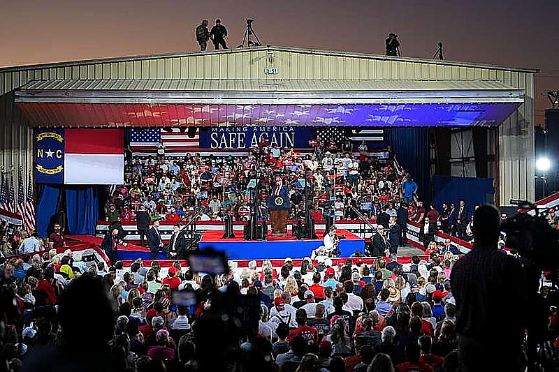 The hangar at Gastonia Municipal Airport, Making America Safe Again, crowd and stage in color. Wire photograph.