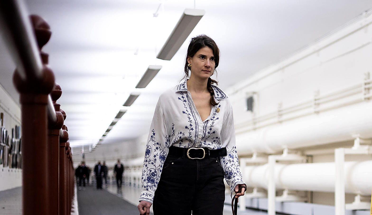 Rep. Marie Gluesenkamp Perez walking a Capitol hallway, full color. Wire photograph.