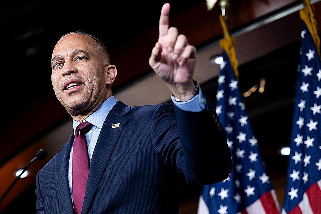 Hakeem Jeffries speaks with one hand raised, outlining what Democrats would do in the first 100 days.