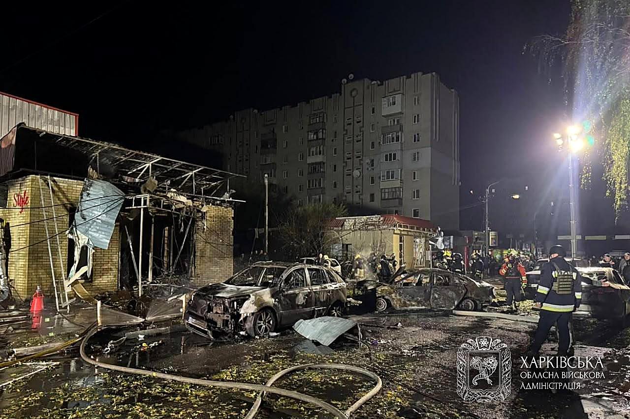 Emergency crews work at night in a smashed Kharkiv district after a Russian strike on energy sites.