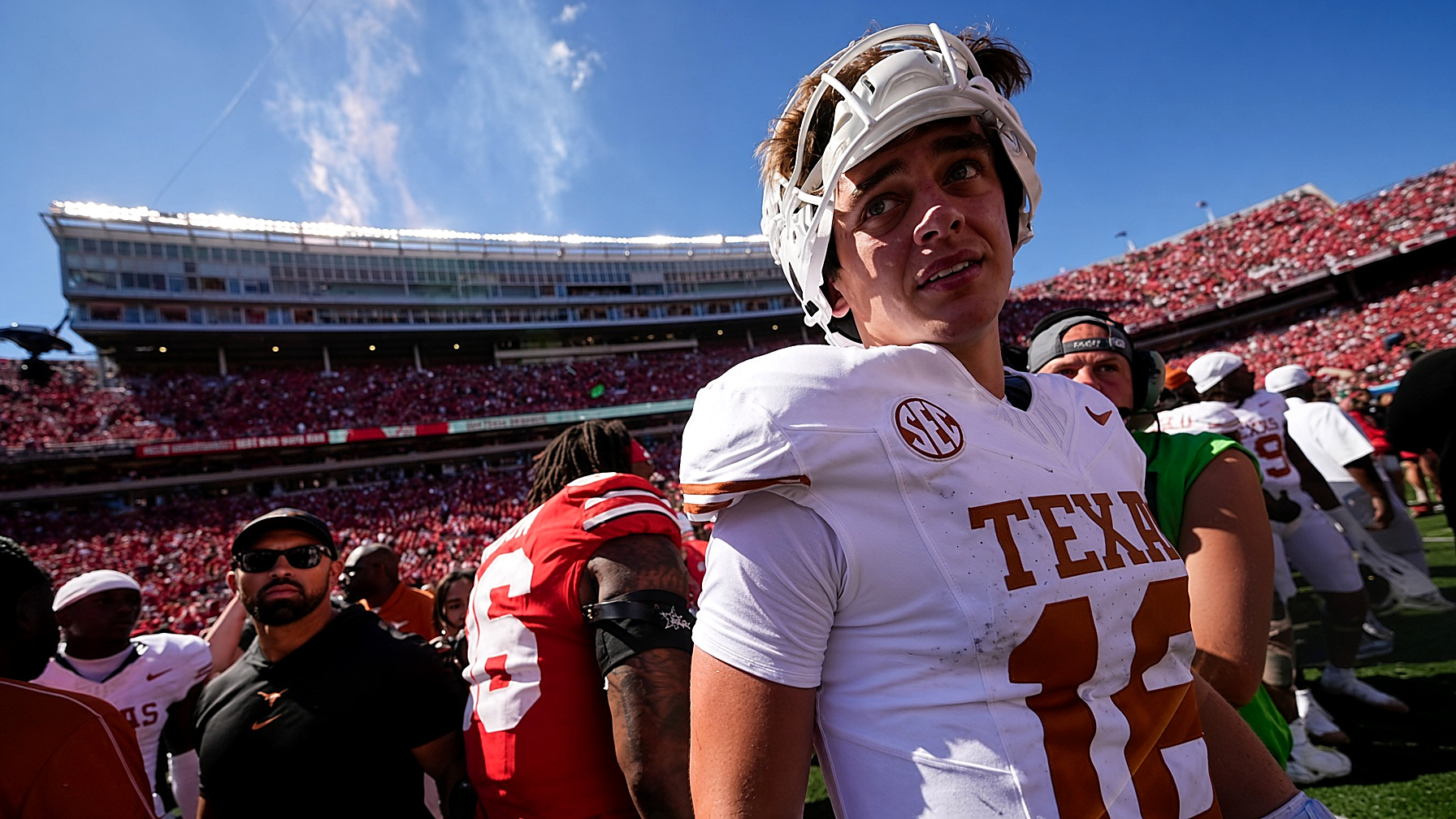Arch Manning in a Texas jersey after the game, full color, stadium crowd behind him. Wire photograph.