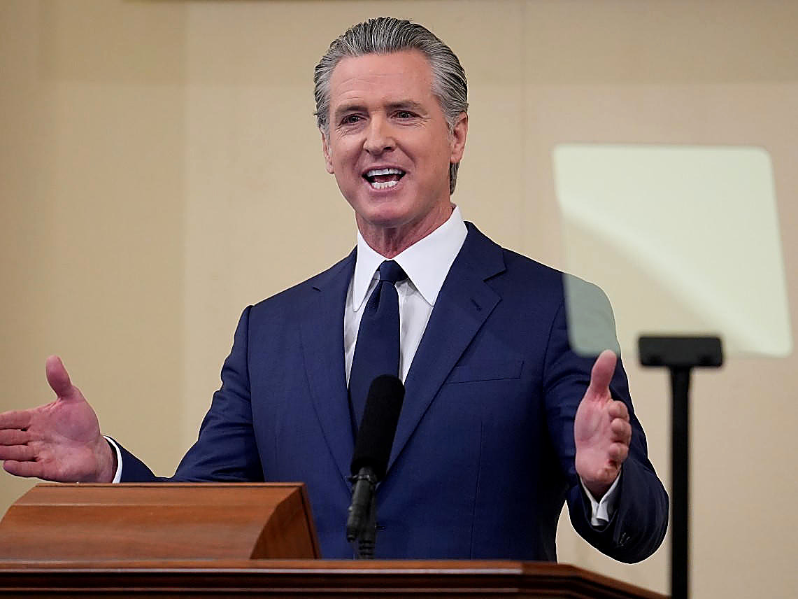 Gov. Gavin Newsom at a podium, full color, navy suit. Wire photograph.