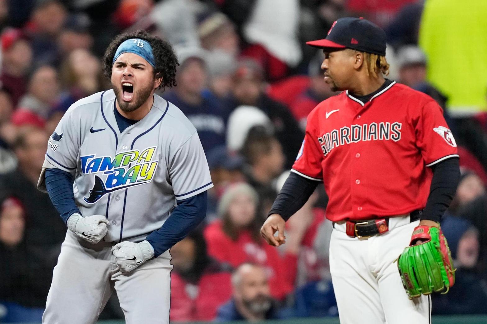 Jonathan Aranda shouts after his seventh-inning single as Guardians third baseman José Ramírez stands beside him.