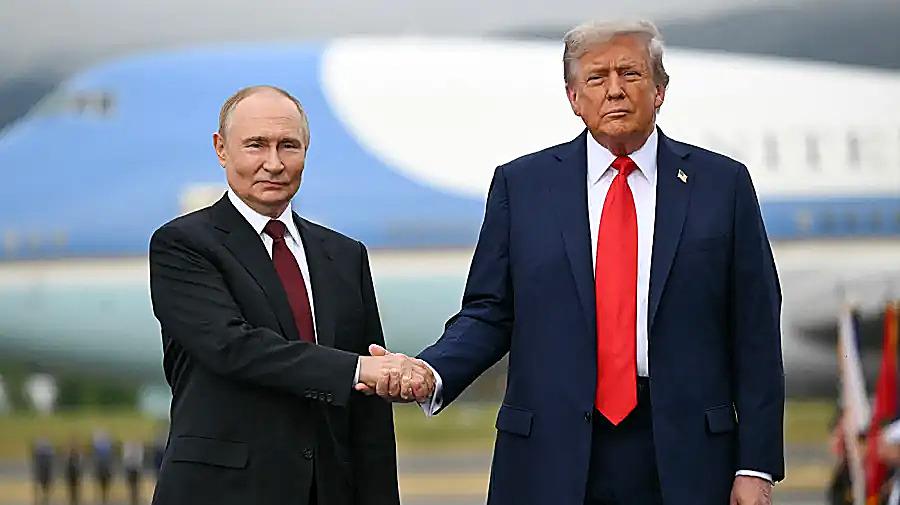 President Trump and President Vladimir Putin shake hands as Trump defends a diesel deal with Russia.