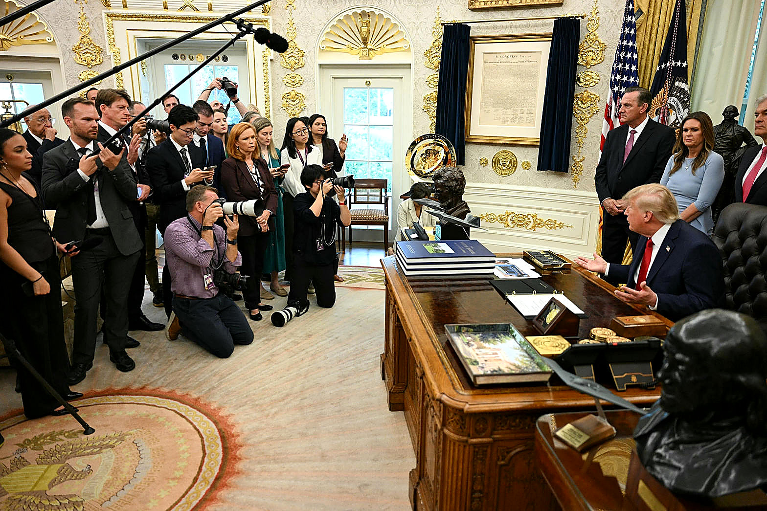 President Trump at a White House podium, full color, navy suit. Wire photograph.