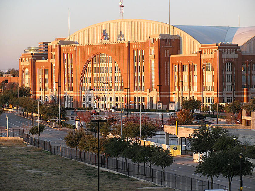The American Airlines Center in Dallas at dusk: brick arches, an empty plaza, no figures in the frame.