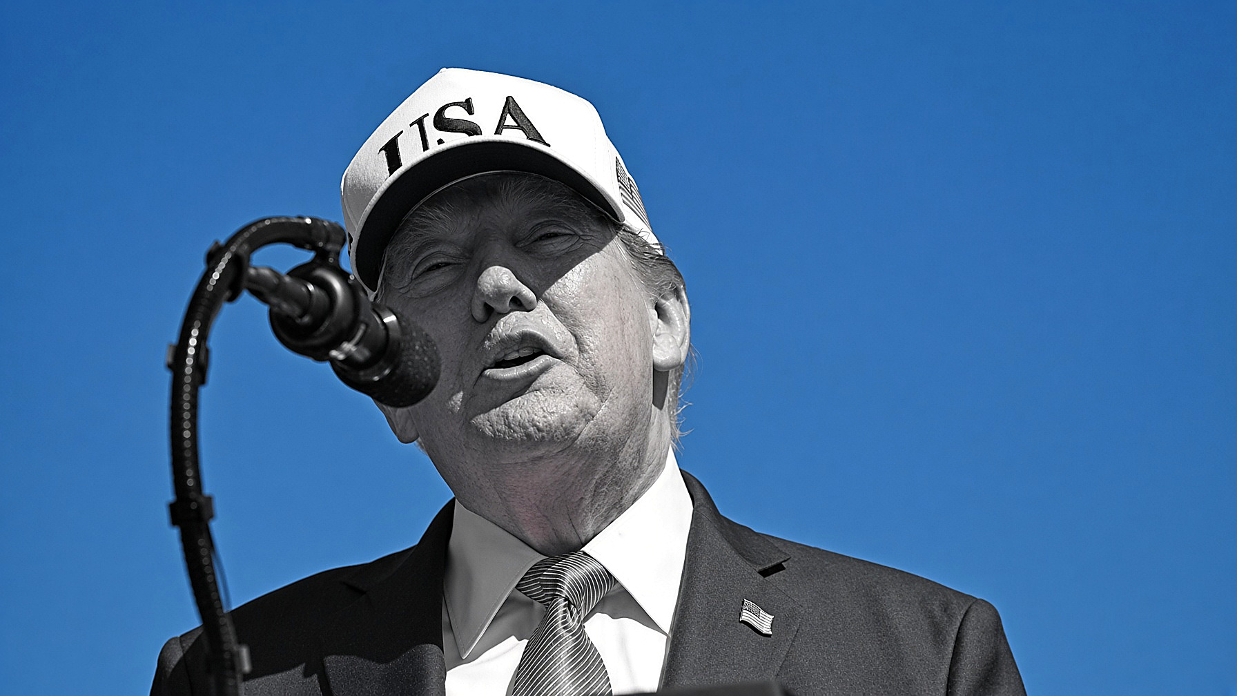 President Trump at a microphone against a blue sky: the figure in black and white — cap, suit, tie, face — the sky in color. Editor’s plate, Wednesday, Sept. 9, 2026.