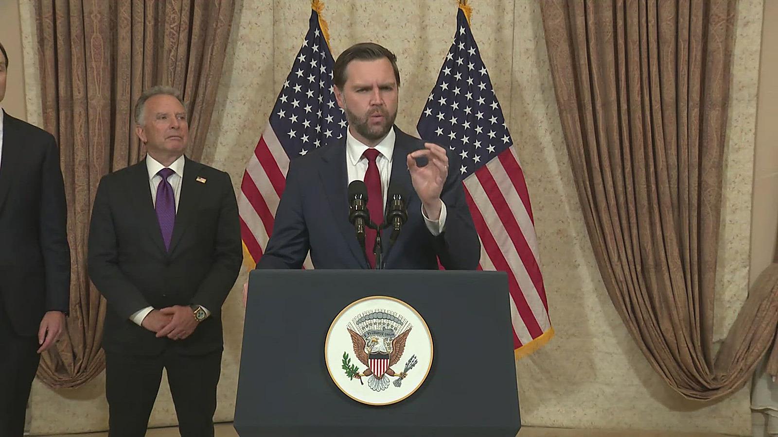 Vice President JD Vance speaks at a podium, one hand raised, on the terms for ending the war.